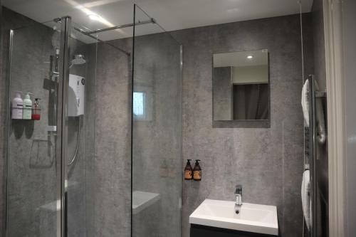 a bathroom with a shower and a sink at Julia's place in Hoylake