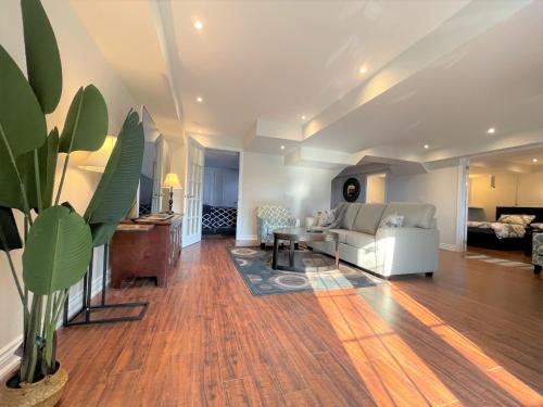a living room with a white couch and a table at Cozy Lovely Ravine facing Suite. in Mississauga