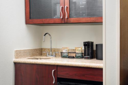 a kitchen counter with a sink in a room at SpringHill Suites Richmond Northwest in Richmond
