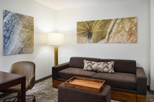 a living room with a couch and a table at SpringHill Suites Richmond Northwest in Richmond