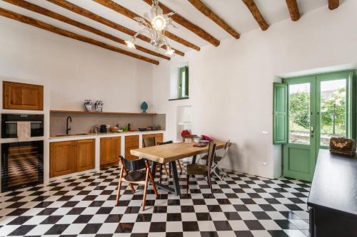a kitchen with a table and a checkered floor at Frangimare - La Malandrina in Malfa