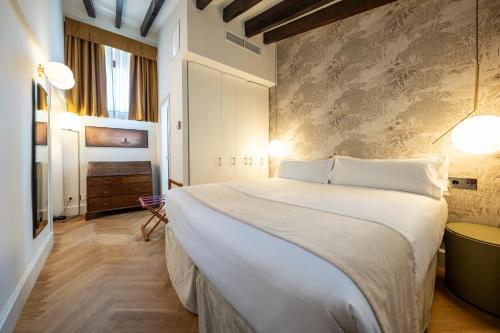 a bedroom with a large white bed in a room at Palacio Ca Sa Galesa in Palma de Mallorca