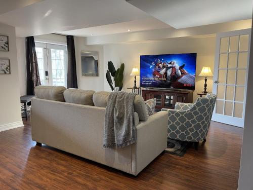 a living room with a couch and two chairs at Cozy Lovely Ravine facing Suite. in Mississauga
