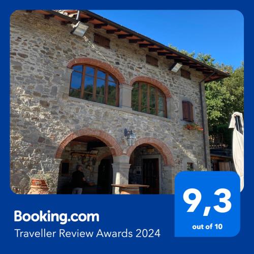 a stone building with a sign that says travel review awards at Agriturismo La Selva di Frena in Firenzuola