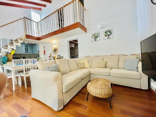 a living room with a white couch and a table at Central Cozy Home Ferragudo in Ferragudo