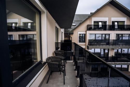 a balcony of a building with chairs and windows at Ribas Karpaty in Bukovel