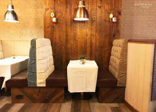 a bathroom with a tub and a sink and a table at Dalmeny Hotel in Lytham St Annes