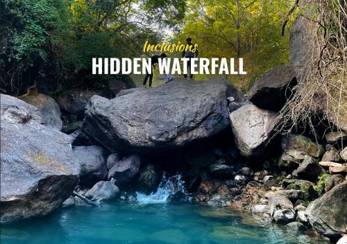 a river with rocks and the words hidden waterfalls at Skyfall 900kandi in Meppādi