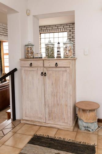 a large wooden cabinet in a room with a window at Barracuda Lodge in Paradise Beach