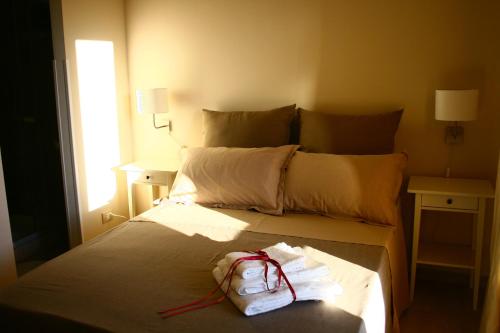 a hotel room with a bed with a bag on it at B&B Il Vulcano in Aci Catena