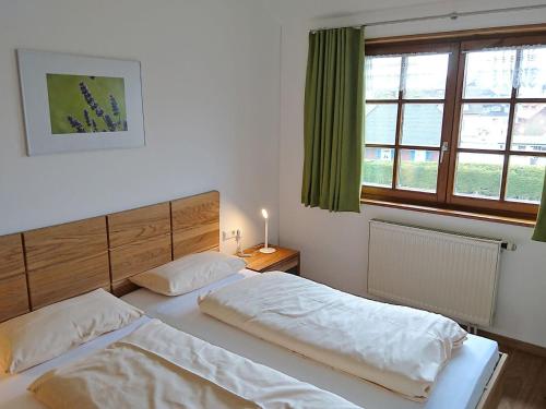 2 łóżka pojedyncze w sypialni z oknem w obiekcie Hermeshof und Biohaus w mieście Titisee-Neustadt