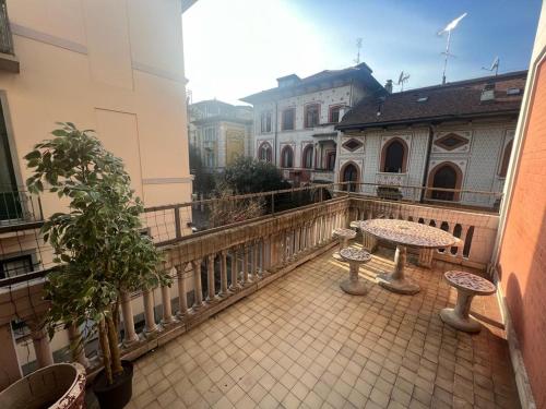 a balcony with tables and chairs on a balcony at Ambra Boutique Hotel in Milan