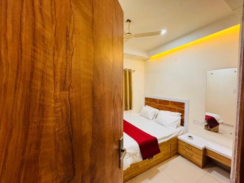 a bedroom with a bed and a mirror at Home Escape 1BHK Apartment Near Bombay Hospital in Indore