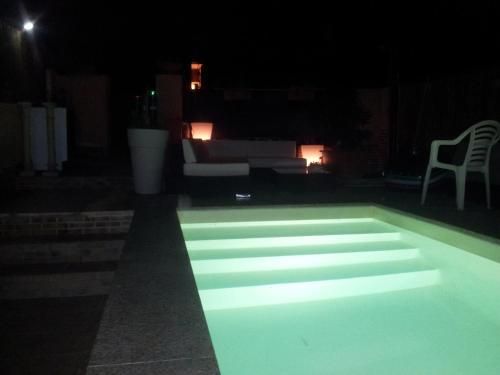 a swimming pool lit up at night at Casa vacanze Valentina in Porto Conte