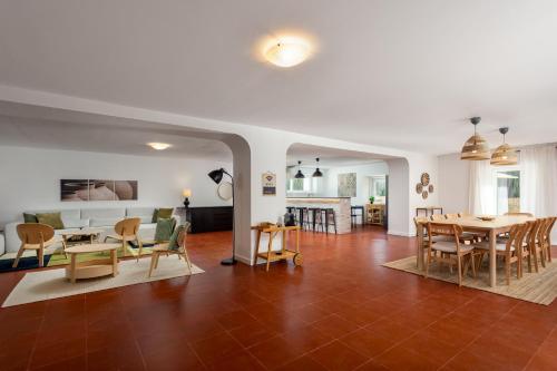 a living room and dining room with a table and chairs at Casa da Azenha - Quinta do Boição - Private pool in Bucelas