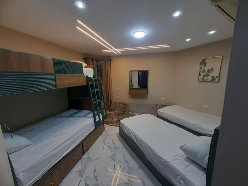 a room with two bunk beds and a mirror at porto said بورتوسعيد in `Ezbet Shalabi el-Rûdi