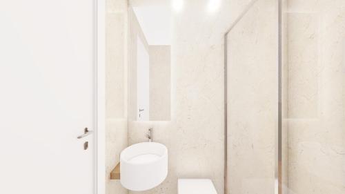 a white bathroom with a toilet and a shower at Relais Badoer in Rome