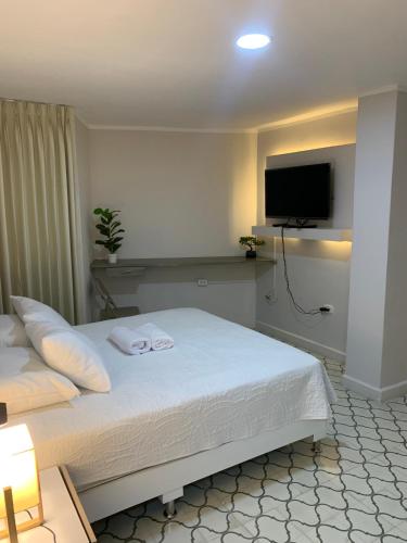 En eller flere senge i et værelse på Apartahotel Edificio Baquero x5 Apto 401