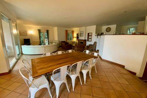 a dining room with a table and white chairs at La Bucolique-Villa in the heart of greenery! in Saint-Jean-de-Védas