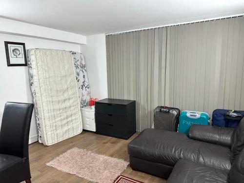 a living room with a couch and a chair at Captivating 1-Bed Apartment in London in London