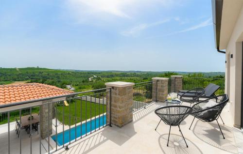 a balcony with chairs and a view of the countryside at Gorgeous Home In Buje With Wifi in Veli Vrh
