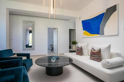 a living room with a couch and a table at Ocean Pearl Sea View in Faliraki