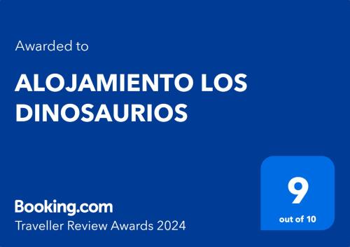 a blue sign with the words albuquerque los dinosauros at ALOJAMIENTO LOS DINOSAURIOS in Cuenca