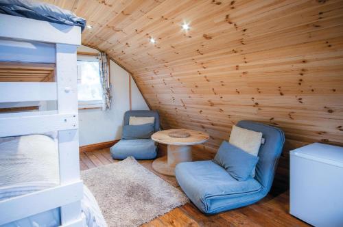 a room with a bunk bed and a table and chairs at The Pod - 1 Bedroom - Freshwest Beach Retreat in Pembroke