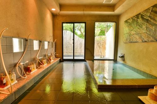 a swimming pool in a room with a pool at Kotonoyado Musashino in Nara
