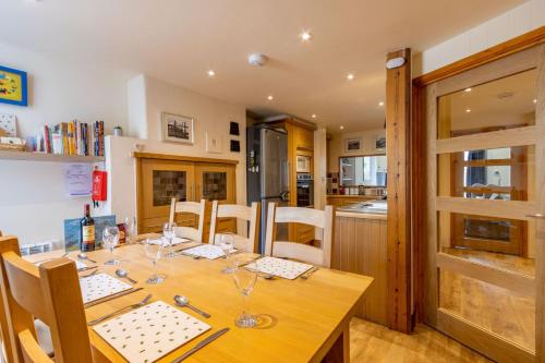 a dining room with a wooden table with wine glasses at Vicary's House in Southwold