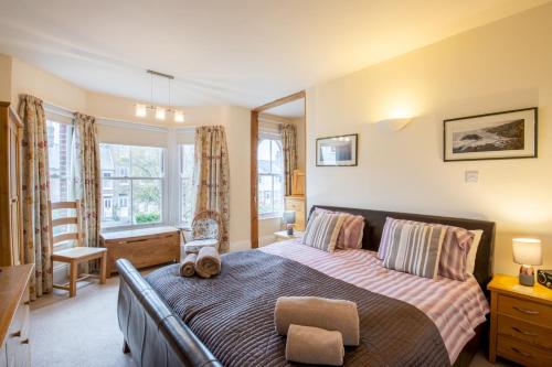 a bedroom with a large bed in a room at Vicary's House in Southwold