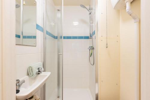 a bathroom with a shower and a sink at Vicary's House in Southwold