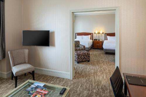 a hotel room with two beds and a mirror at Hilton Cincinnati Netherland Plaza in Cincinnati