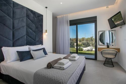 a bedroom with a large bed with towels on it at Ocean Pearl Sea View in Faliraki