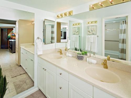 a bathroom with two sinks and a large mirror at Phoenix Vacation Rentals in Phoenix