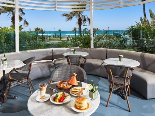 a table with plates of food on a patio at Villa Blanca Urban Hotel in Casablanca