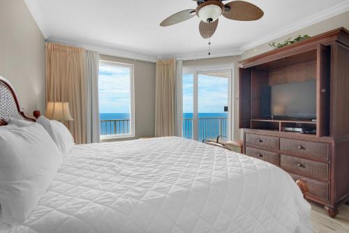a bedroom with a large bed and a television at Grandview East 1204 in Panama City Beach