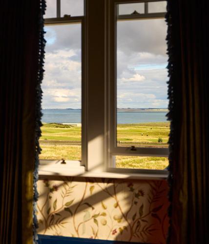 an open window with a view of the ocean at Dornoch Station in Dornoch