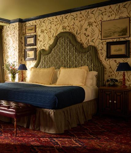 a bedroom with a large bed with a blue comforter at Dornoch Station in Dornoch