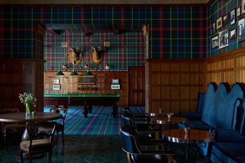 a restaurant with tables and chairs and a pool table at Dornoch Station in Dornoch