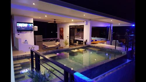 a swimming pool in the middle of a house at night at Penthouse Crystal Bay Apartments in Ban Lamai