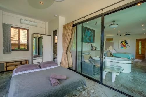 a bedroom with a bed and a tub and a sink at Penthouse Crystal Bay Apartments in Ban Lamai