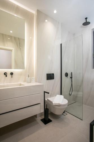 a bathroom with a sink and a toilet and a shower at Ocean Pearl Sea View in Faliraki