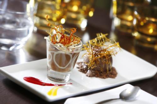 a white plate with two desserts on a table at Best Western Ship Hotel in Weybridge