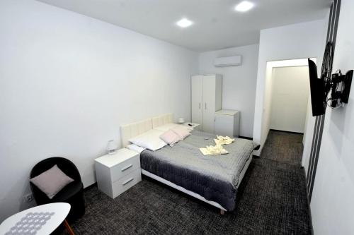 a bedroom with a bed and a desk and a chair at Villa Sovita in Łeba