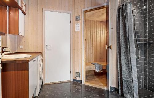 a bathroom with a shower and a sink at Nice Home In Fjerritslev With Sauna in Fjerritslev