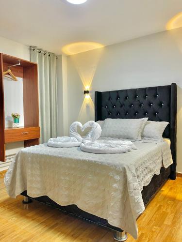 a bedroom with a large bed with towels on it at Jultom Inn Hotel & Suites in Trujillo