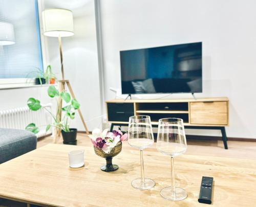 a living room with two wine glasses on a table at Turku Central Luxury Modern Cozy Flat 69m2 in Turku