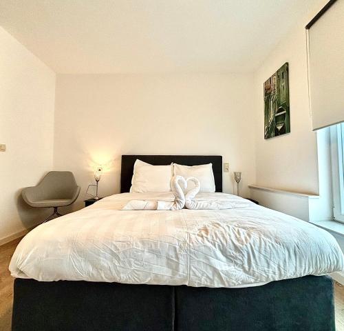 a bedroom with a large bed with a bow on it at Il Casolare in Beersel