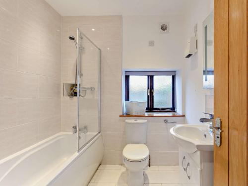 a white bathroom with a toilet and a sink at 2 bed in Barnstaple 28959 in Chapelton